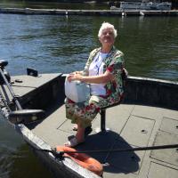 Glenda has the front seat on the boat to Bluff Point