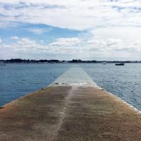 Concrete pier disappearing into the water becomes more useable at low tide.